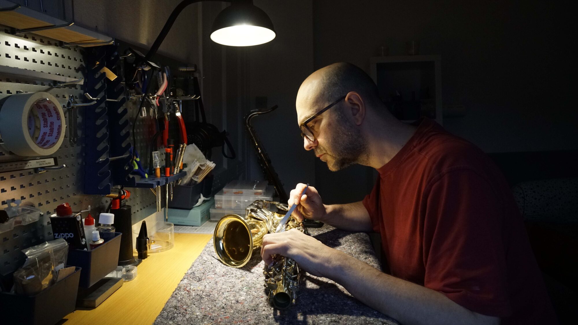 Morten repairing a saxophone in his workshop, Det Lille Saxofonværksted in Odense